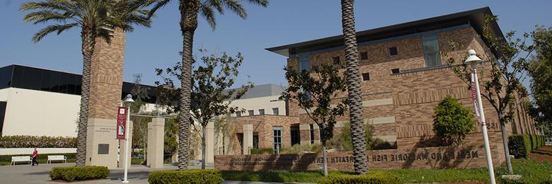 outside of the interfaith center on a sunny day with palm trees